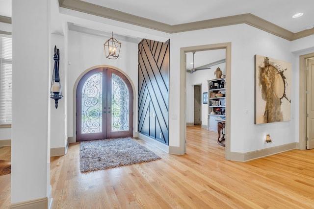 1041 Albatross Way, Gallatin, TN 37066 - foyer entrance with arched walkways, french doors, crown molding, light wood-style floors, and a chandelier