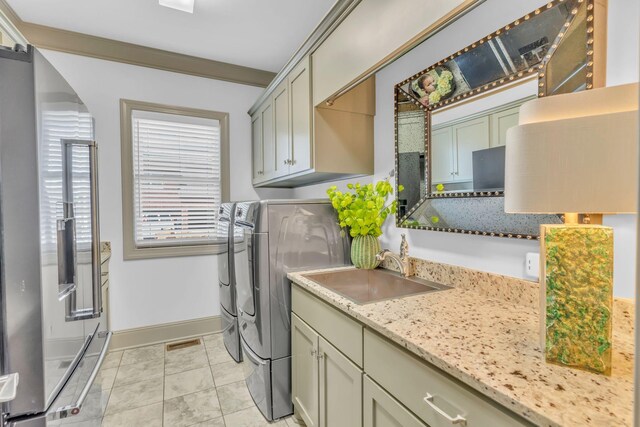 1041 Albatross Way, Gallatin, TN 37066 - laundry room featuring washer and clothes dryer, baseboards, and cabinet space