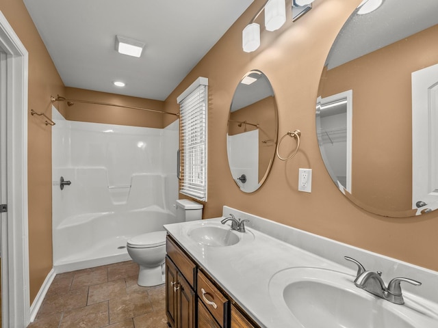 30 Sullivan Ln, Tullahoma, TN 37388 - full bathroom featuring toilet, a shower, stone finish flooring, baseboards, and double vanity