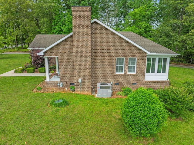 30 Sullivan Ln, Tullahoma, TN 37388 - view of side of home with a chimney, central air condition unit, a yard, crawl space, and brick siding
