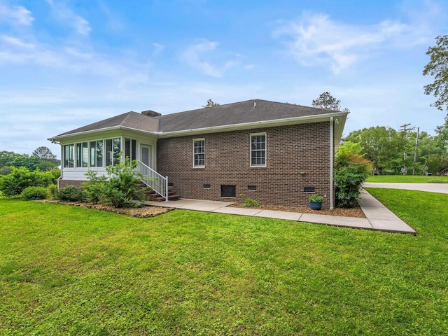 30 Sullivan Ln, Tullahoma, TN 37388 - rear view of house featuring crawl space, a lawn, brick siding, a sunroom, and a patio area