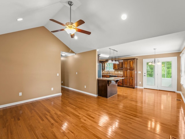 30 Sullivan Ln, Tullahoma, TN 37388 - unfurnished living room featuring a ceiling fan, baseboards, light wood-style flooring, vaulted ceiling, and a sink