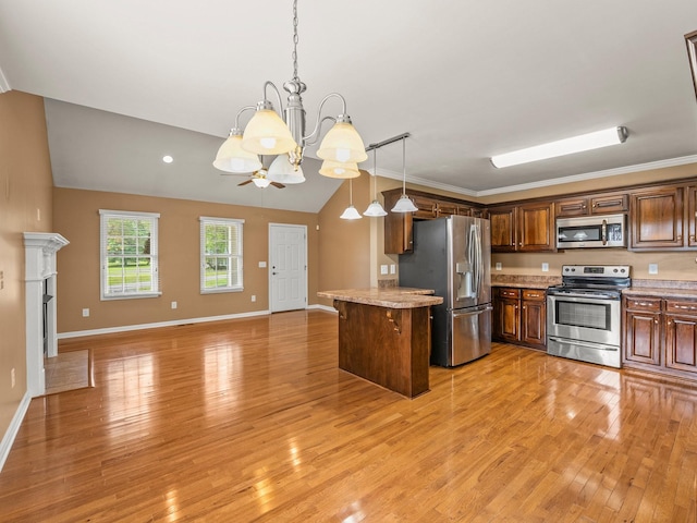 30 Sullivan Ln, Tullahoma, TN 37388 - kitchen with appliances with stainless steel finishes, vaulted ceiling, a chandelier, light wood-style floors, and open floor plan