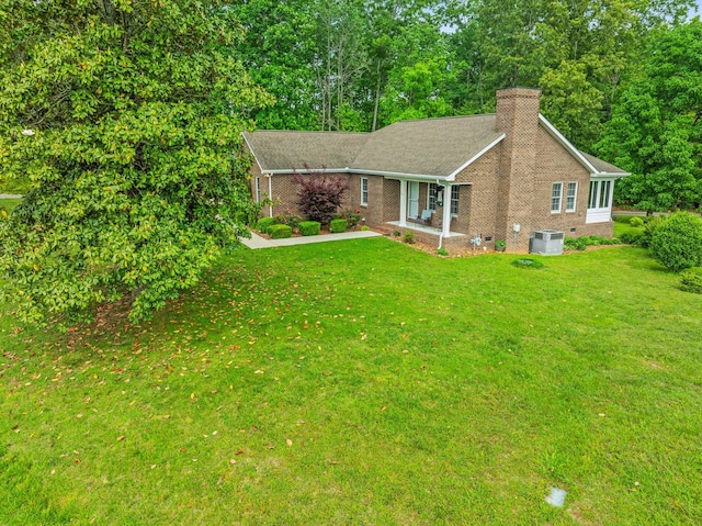 30 Sullivan Ln, Tullahoma, TN 37388 - ranch-style house with cooling unit, a chimney, brick siding, and a front lawn