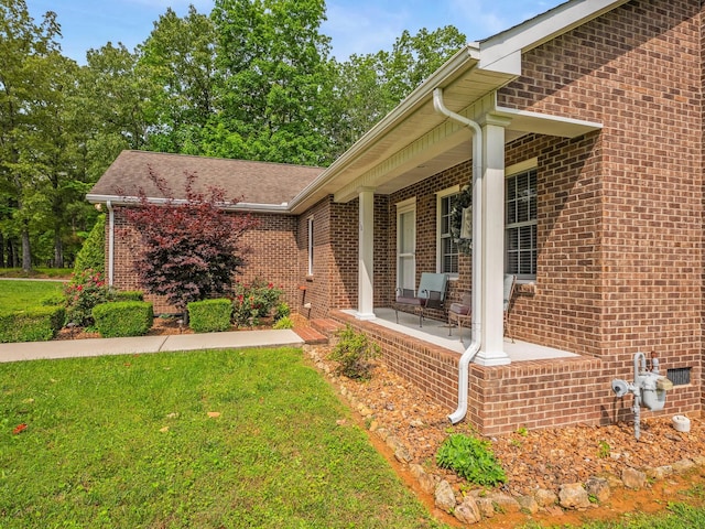 30 Sullivan Ln, Tullahoma, TN 37388 - view of property exterior featuring covered porch, brick siding, and a lawn