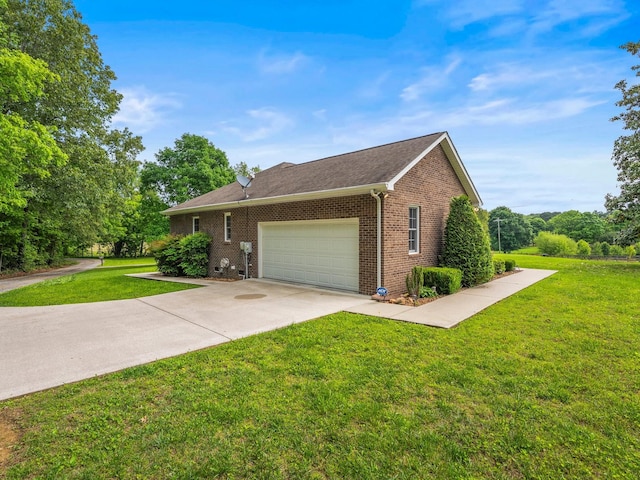 30 Sullivan Ln, Tullahoma, TN 37388 - view of front of home with brick siding, an attached garage, driveway, and a front yard