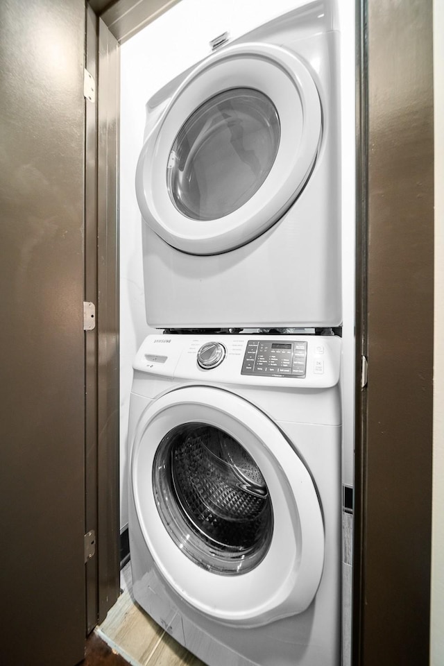 clothes washing area featuring stacked washer / dryer