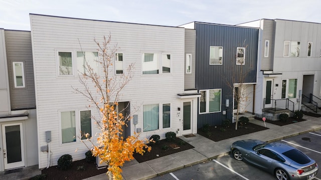 multi unit property featuring uncovered parking and board and batten siding