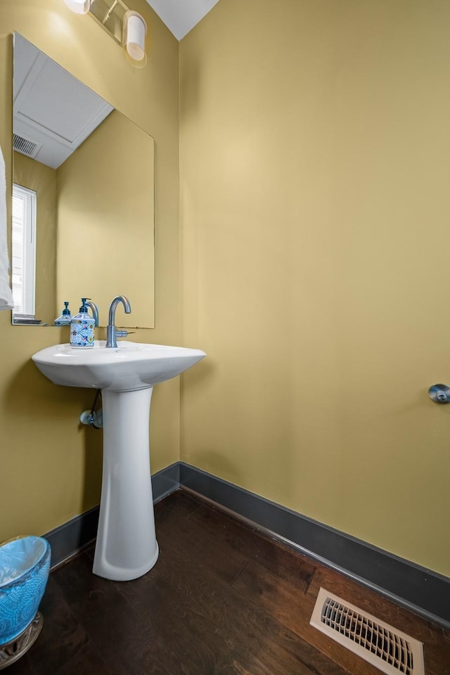 bathroom featuring wood finished floors and baseboards