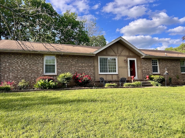 single story home featuring brick siding and a front yard