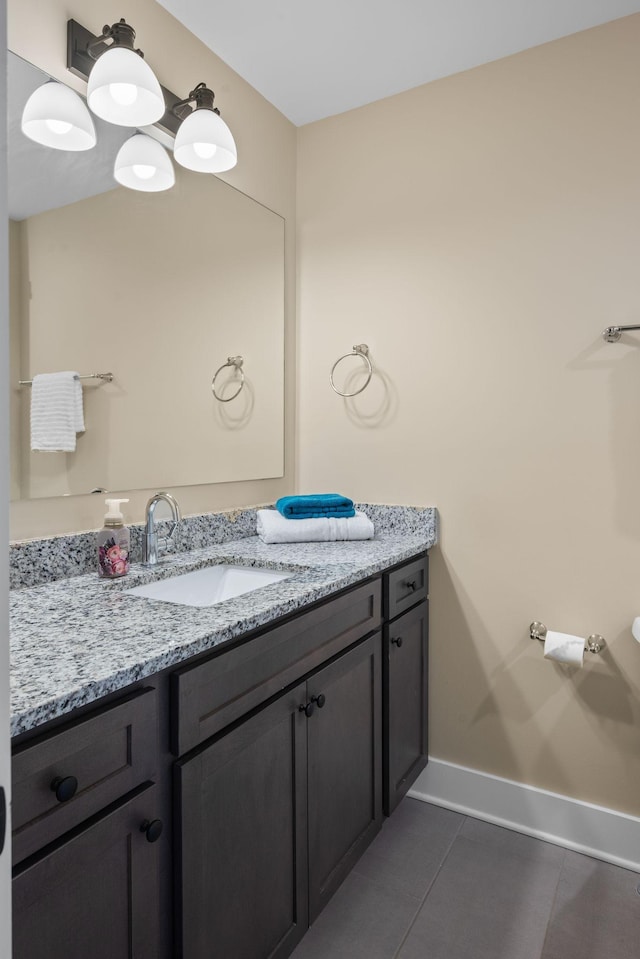 bathroom featuring vanity, tile patterned flooring, and baseboards