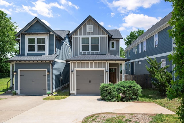 view of front of home with board and batten siding, fence, a garage, concrete driveway, and roof with shingles