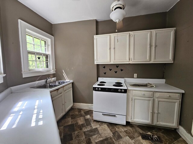 4 Mother Goose Vlg, Lookout Mountain, GA 30750 - kitchen with white electric stove, baseboards, stone finish flooring, a sink, and light countertops