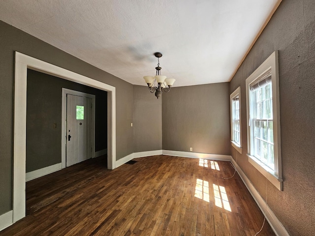 4 Mother Goose Vlg, Lookout Mountain, GA 30750 - unfurnished dining area featuring a chandelier, dark wood-style floors, a textured wall, and baseboards