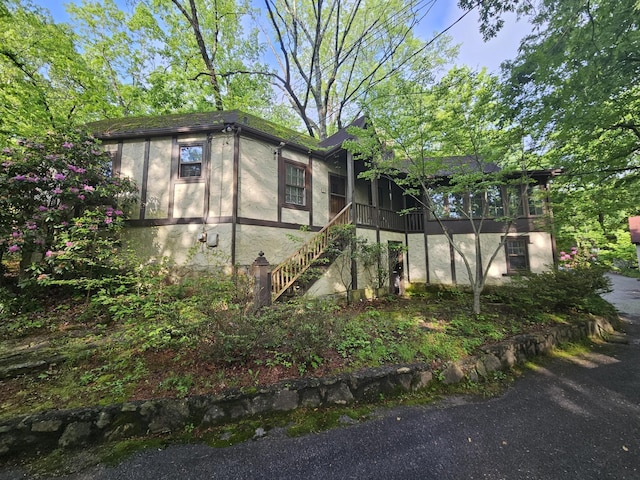 4 Mother Goose Vlg, Lookout Mountain, GA 30750 - view of side of home with stairway, a sunroom, and stucco siding