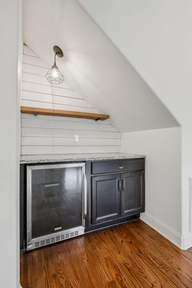 detailed view of beverage cooler and wood finished floors