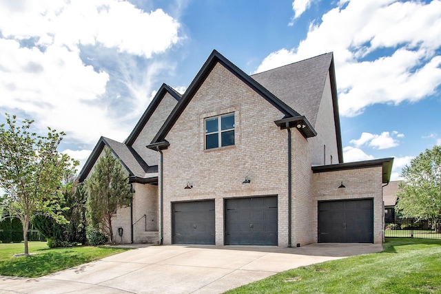 view of home's exterior featuring brick siding, a garage, and driveway