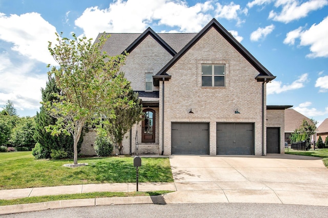 view of front of property with brick siding, a garage, a front lawn, and driveway