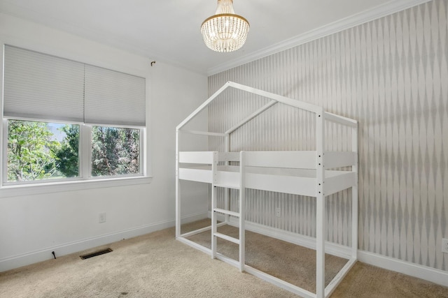 unfurnished bedroom with carpet floors, a chandelier, ornamental molding, and baseboards