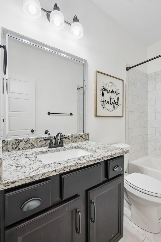 bathroom with toilet, vanity, and shower / bath combination