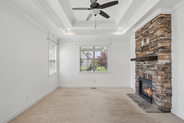 unfurnished living room featuring a fireplace, ceiling fan, carpet flooring, and crown molding