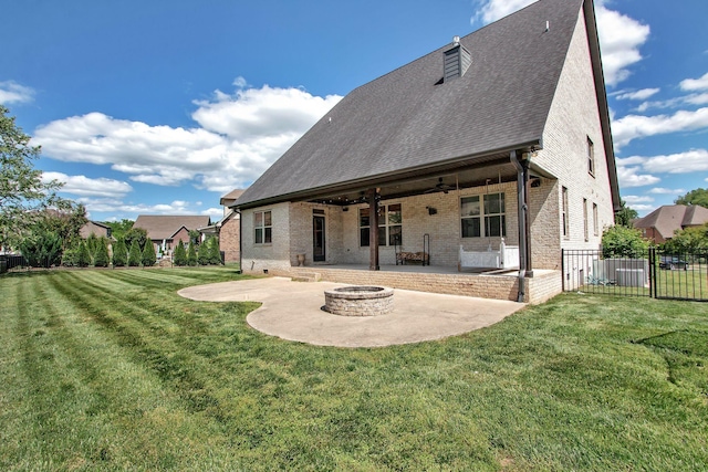 back of house featuring a patio area, brick siding, a fire pit, a ceiling fan, and a shingled roof