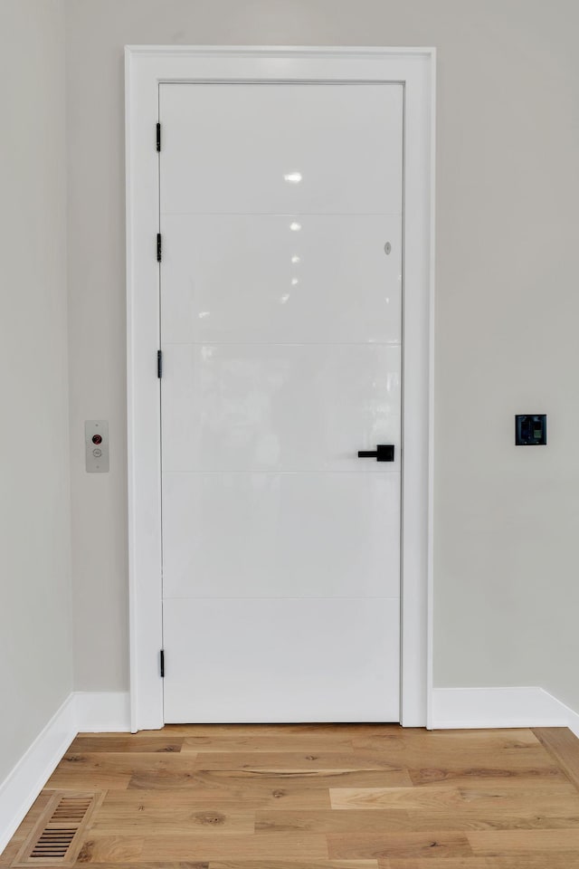 entryway featuring light wood-style flooring and baseboards