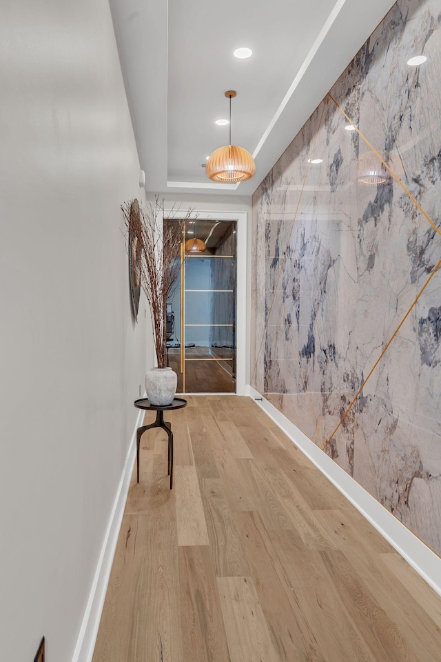 hallway with wood finished floors and recessed lighting