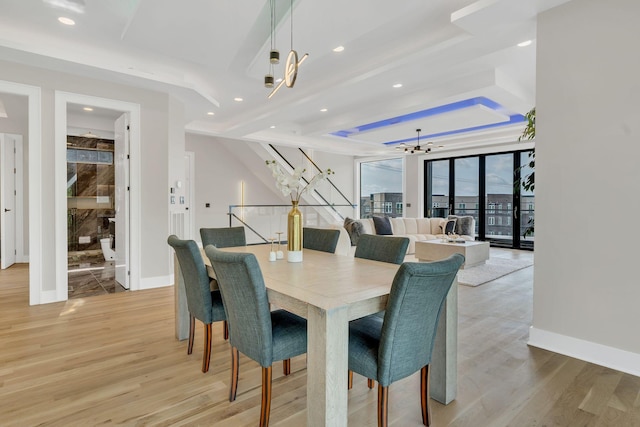 dining space with a chandelier, light wood-style floors, recessed lighting, and baseboards