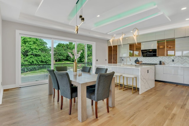 dining space featuring plenty of natural light, light wood finished floors, and recessed lighting