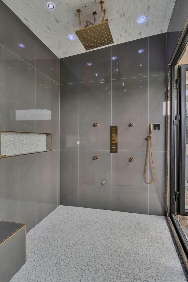 bathroom with a tile shower and recessed lighting