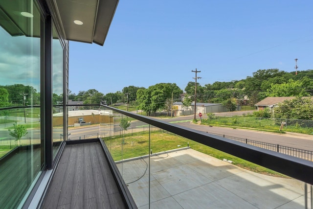 balcony featuring view of wooded area