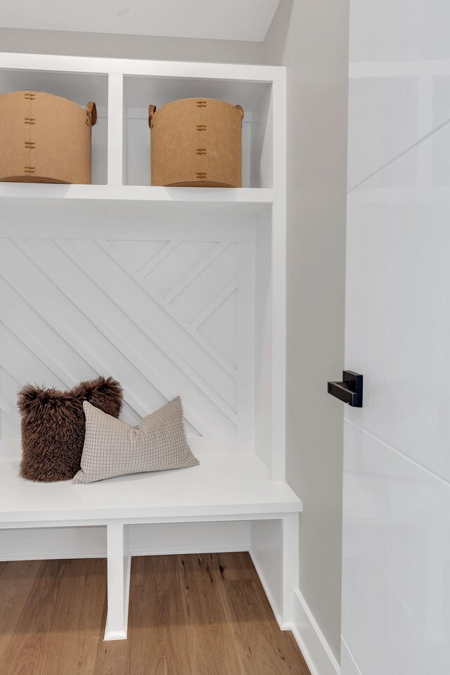 mudroom with wood finished floors and baseboards