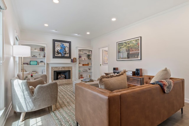 3060 Liberty Hills Dr, Franklin, TN 37067 - living room featuring a premium fireplace, wood finished floors, ornamental molding, recessed lighting, and built in shelves