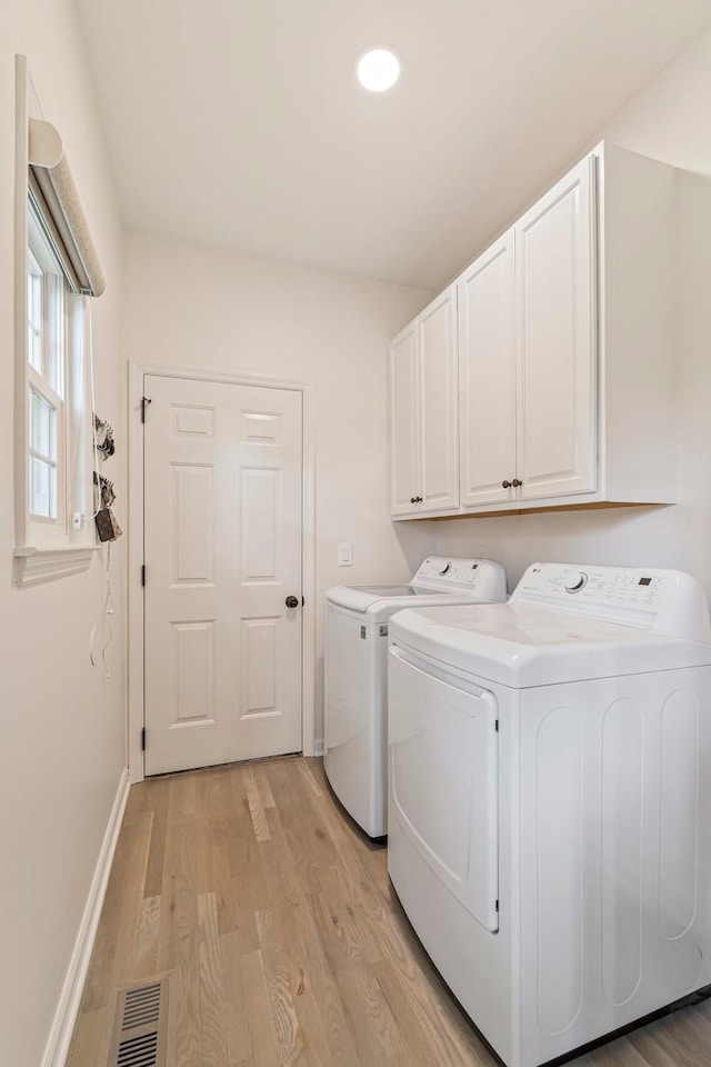3060 Liberty Hills Dr, Franklin, TN 37067 - clothes washing area featuring washing machine and dryer, cabinet space, light wood-type flooring, and baseboards