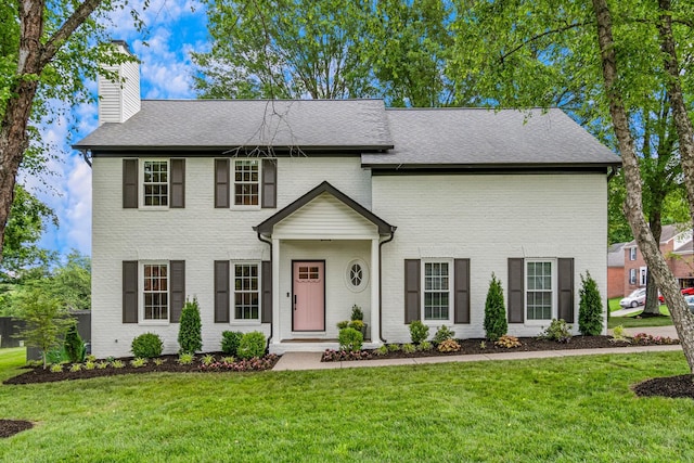 3060 Liberty Hills Dr, Franklin, TN 37067 - view of front facade featuring a chimney, a front yard, brick siding, and roof with shingles