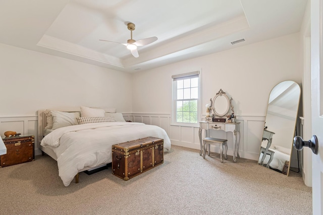 3060 Liberty Hills Dr, Franklin, TN 37067 - carpeted bedroom featuring a raised ceiling, a decorative wall, wainscoting, and a ceiling fan