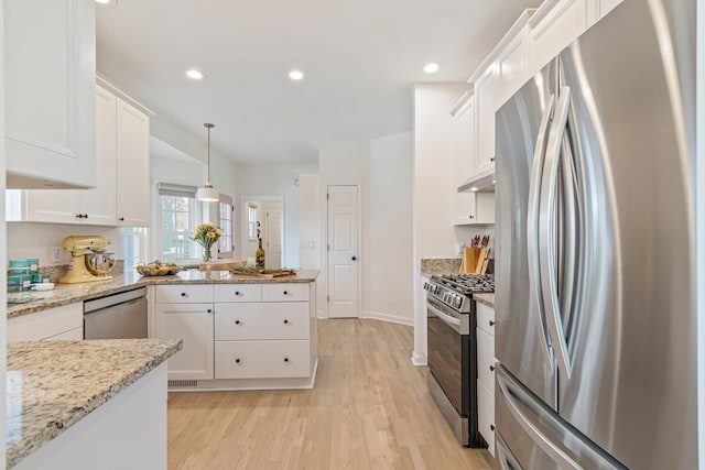 3060 Liberty Hills Dr, Franklin, TN 37067 - kitchen featuring appliances with stainless steel finishes, white cabinetry, light wood finished floors, a peninsula, and recessed lighting
