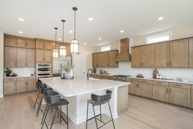 2955 Hunt Valley Dr, Spring Hill, TN 37174 - kitchen featuring custom range hood, double oven, a kitchen bar, tasteful backsplash, and a center island with sink