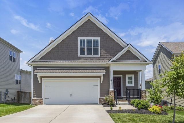 6014 Doster Rd, Smyrna, TN 37167 - craftsman-style home featuring covered porch, concrete driveway, stone siding, and a garage