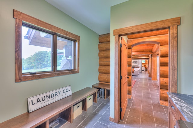 1271 Bivins Rd, Lewisburg, TN 37091 - hall with log walls, arched walkways, and dark tile patterned flooring
