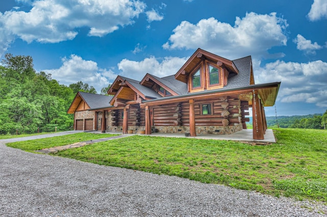 1271 Bivins Rd, Lewisburg, TN 37091 - log-style house with log siding, a front lawn, driveway, and an attached garage