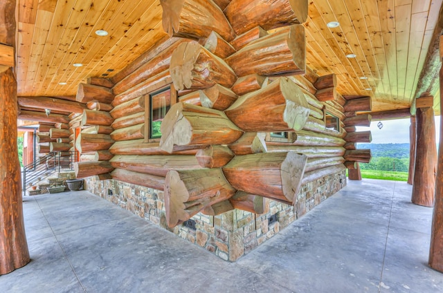 1271 Bivins Rd, Lewisburg, TN 37091 - miscellaneous room with unfinished concrete floors, rustic walls, and wood ceiling