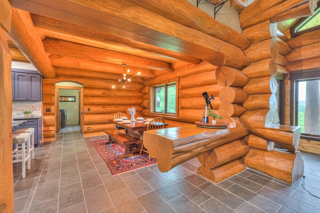 1271 Bivins Rd, Lewisburg, TN 37091 - dining room with arched walkways, dark tile patterned floors, beam ceiling, and a chandelier