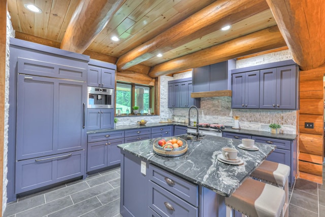 1271 Bivins Rd, Lewisburg, TN 37091 - kitchen featuring dark tile patterned flooring, a kitchen bar, tasteful backsplash, recessed lighting, and wood ceiling