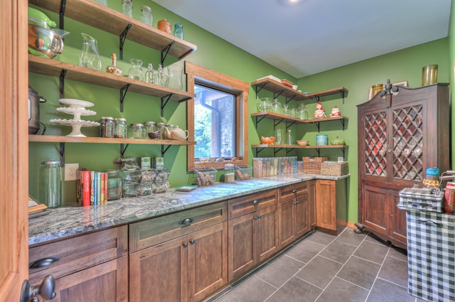 1271 Bivins Rd, Lewisburg, TN 37091 - kitchen with open shelves, dark tile patterned floors, and light stone counters