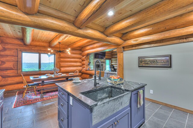 1271 Bivins Rd, Lewisburg, TN 37091 - kitchen with a sink, wood ceiling, dark stone countertops, beam ceiling, and log walls