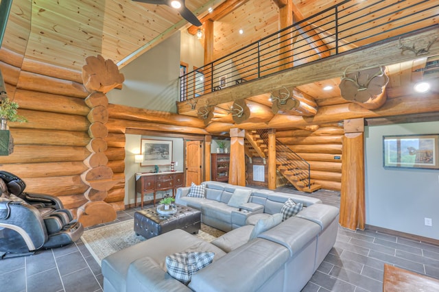 1271 Bivins Rd, Lewisburg, TN 37091 - living area featuring stairs, log walls, tile patterned flooring, wooden ceiling, and a towering ceiling