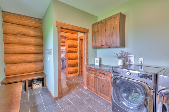 1271 Bivins Rd, Lewisburg, TN 37091 - laundry area with log walls, cabinet space, washer and dryer, and dark tile patterned floors