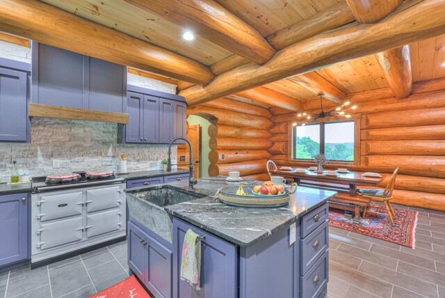 1271 Bivins Rd, Lewisburg, TN 37091 - kitchen featuring a sink, tile patterned flooring, stainless steel gas cooktop, arched walkways, and decorative backsplash